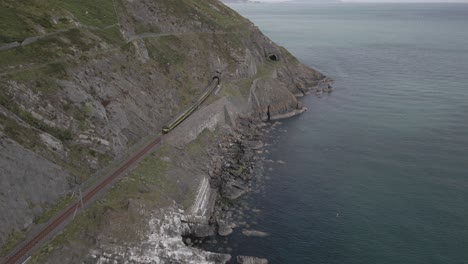 Train-Entering-Railway-Tunnel-In-Coastal-Cliff-In-County-Wicklow,-Ireland