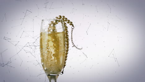 animation of pearl necklace falling into glass of champagne on white background