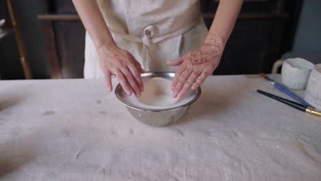 woman creating a ceramic bowl