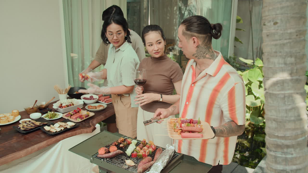 Multi-ethnic Friends Cooking Together during Barbecue Party
