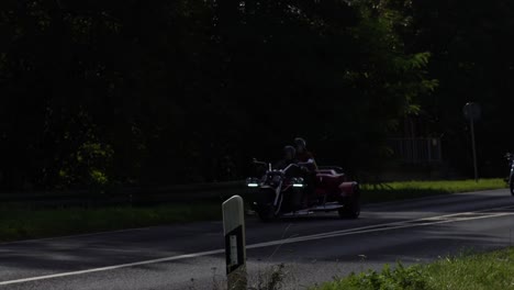morobikes are passing along a road in goldbach, germany, creating a scene of active transportation and environmental consciousness.
