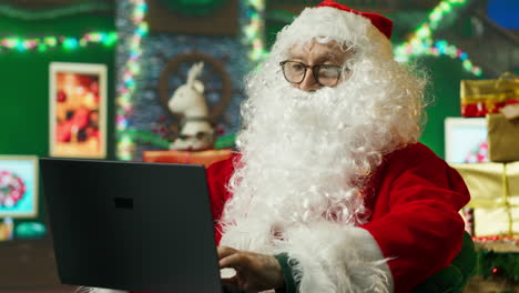 santa claus working on a laptop