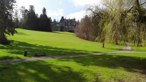 beautiful fairy tale castle in a big park with a lake and trees