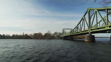 glienicke bridge across the havel river in germany on winder day - time lapse of people walking and water flowing