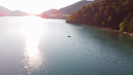 Canoa-De-Agua-De-Verano-En-Medio-Del-Lago-En-Austria,-Vista-Aérea,-Hora-Dorada