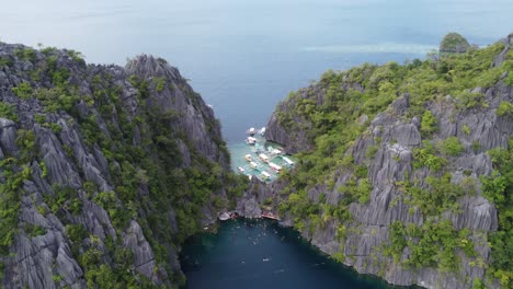 tour boats and snorkelers at barracuda lake in coron, aerial reveal