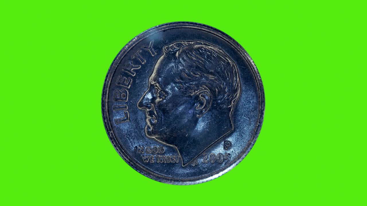 una moneda de diez centavos brilla en los rayos de luz