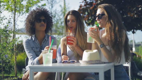 women having drinks in summer day