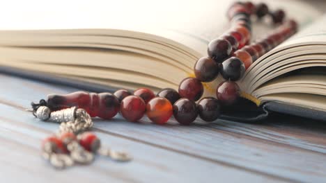 open quran with prayer beads