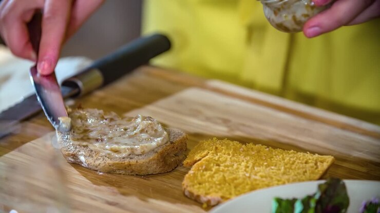 Closeup chef spread chicken liver on pate slice Podvelka, Slovenia, slowmo