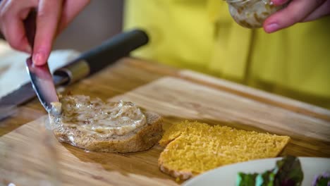 Closeup-chef-spread-chicken-liver-on-pate-slice-Podvelka,-Slovenia,-slowmo