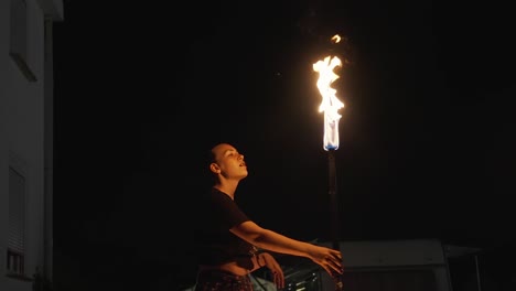 the darkness of night is the perfect backdrop for this artist performing a thrilling fire show