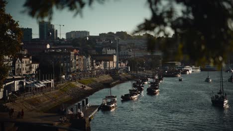 Vila-Nova-de-Gaia-ribeira,-promenade-by-the-Douro-River-with-rabelo-boats-in-Porto