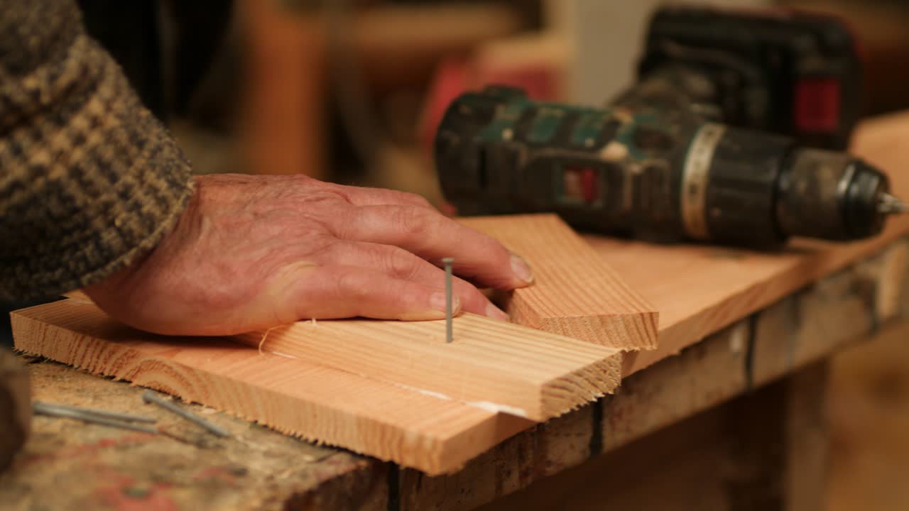 Hammering steel nail into wood, Boat Construction Process