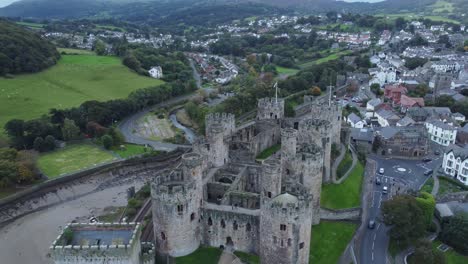 medieval conwy castle walled old market town aerial view countryside reveal