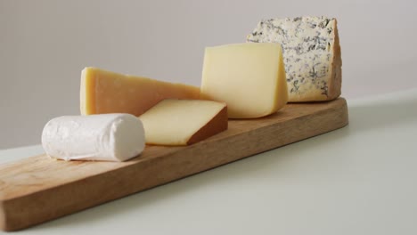 Video-of-assorted-hard-and-soft-cheeses-on-wooden-chopping-board