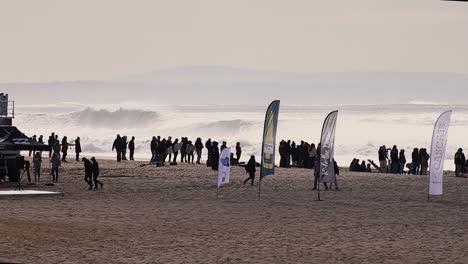 Wide-shot,-WSL-surf-championship,-crowded-on-the-beach,-Carcavelos-beach