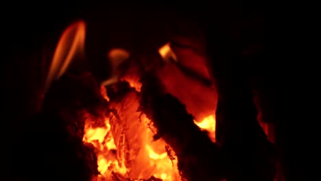 a steady slow motion shot of a hot fire burning and embers glow orange