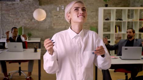 young happy businesswoman is dancing in office, colleagues are clapping, work concept, relax concept