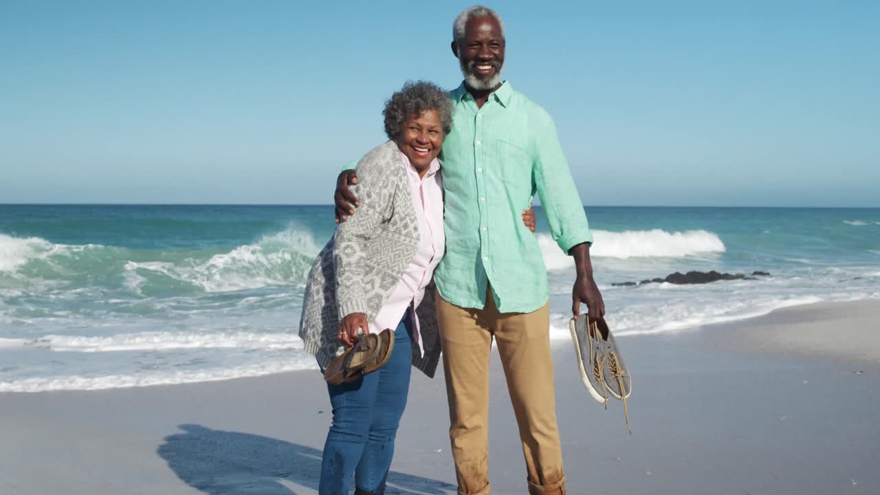Senior couple standing together at the beach
