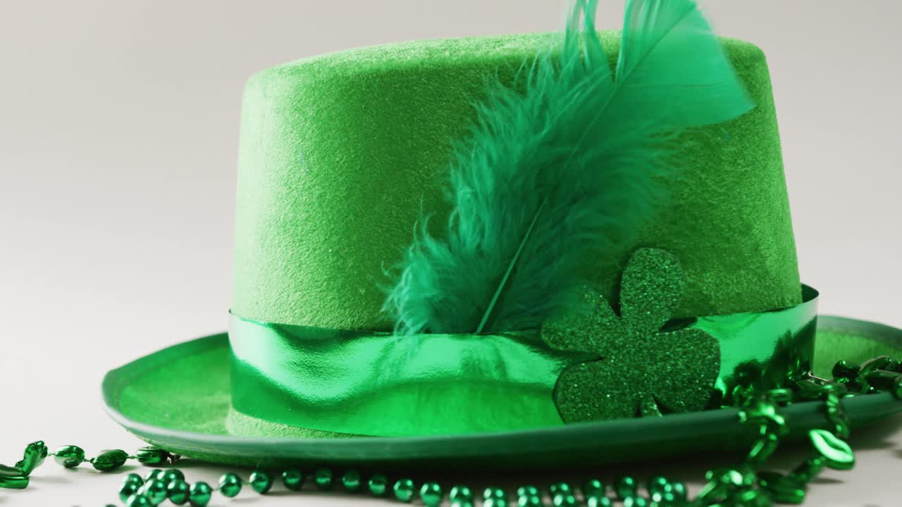 Video of st patrick's green hat and necklace with copy space on white background