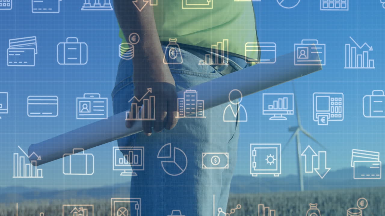 Male engineer holding blueprint tube in wind farm, overlaying finance charts and credit card icons