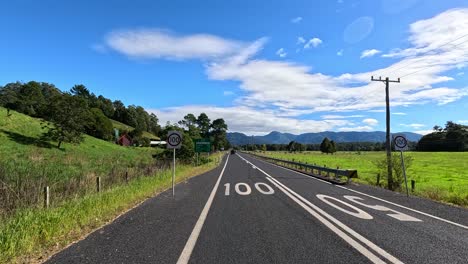 country road with landslide warning and scenic views