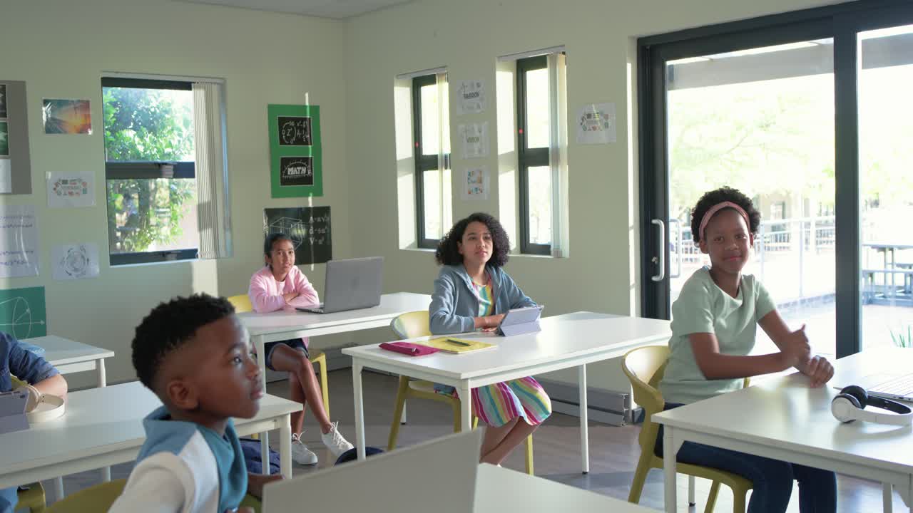 Teacher with youth students asking question in class, central girl raising hand to answer laptop