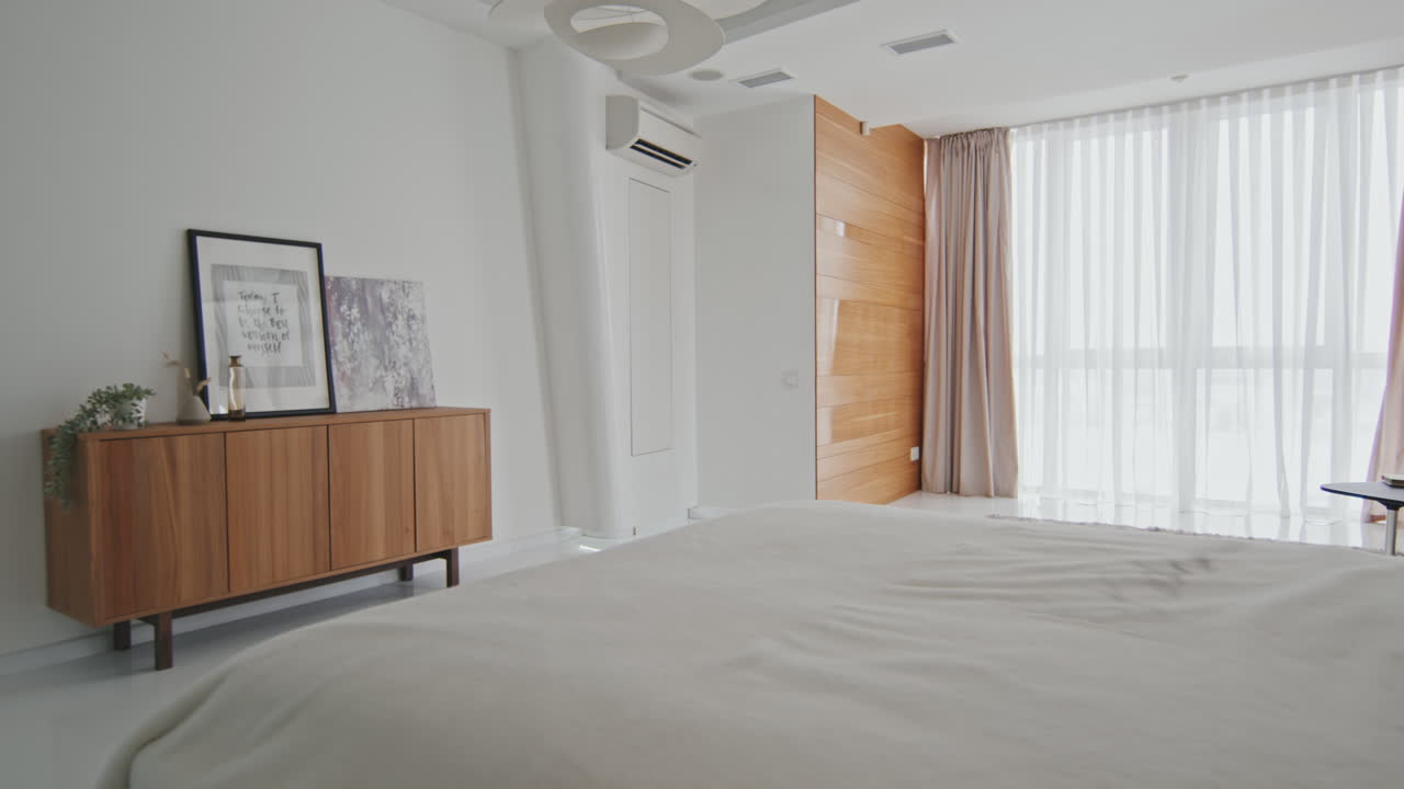 PAN Of Spacious Minimalist Bedroom In Modern Apartment