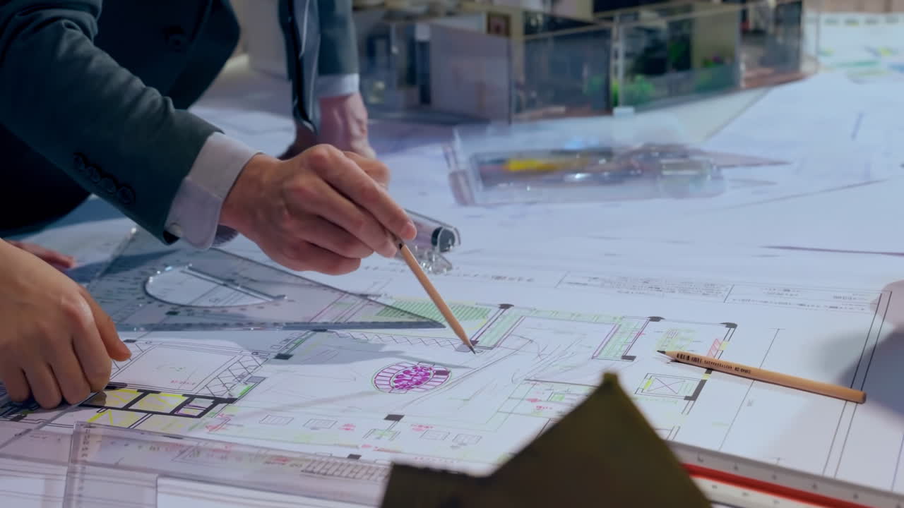 Top down view of Architect team brainstorming idea and planning building design about house project while sitting at table with plan.