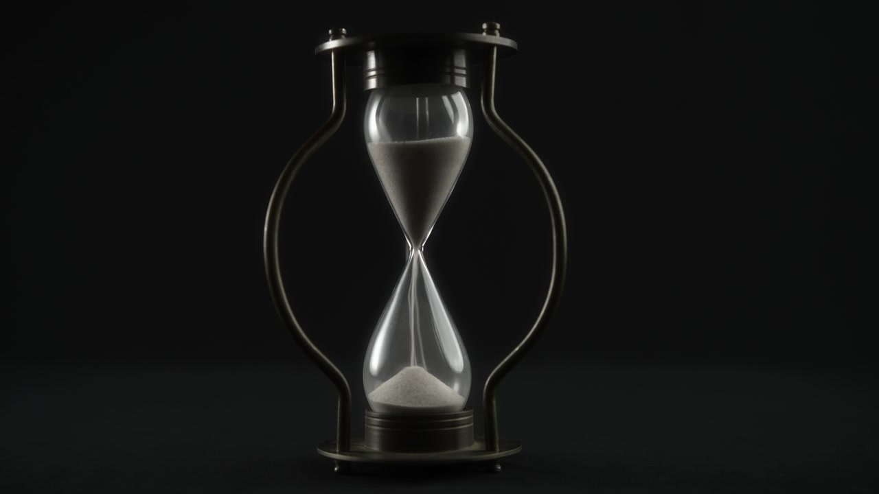 Vintage Hourglass Measuring Time Against a Dark Background