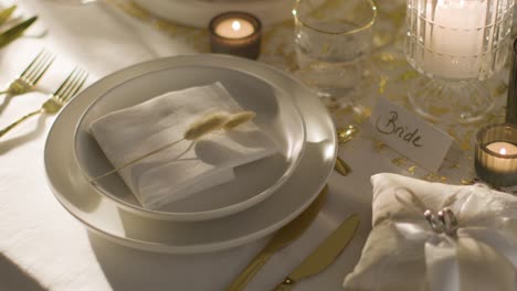 table set for meal at wedding reception with place card for bride and rings 2