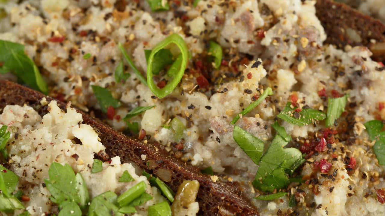 cocina israelí. forshmak con perejil y especias en pan de centeno negro de primer plano. plato nacional de arenque judío, cultura de oriente medio. bocadillo tradicional vorschmack hecho de filete de pescado giratorio