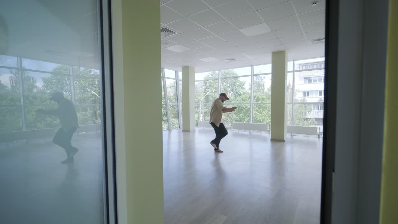 Stylish young man dancing break dance and choreography. Performance, movement, style and fashion concept