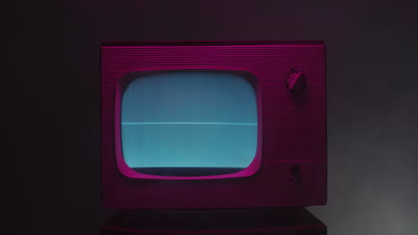 vintage retro tv with pink lighting and static