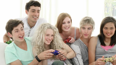 teenagers playing video games at home