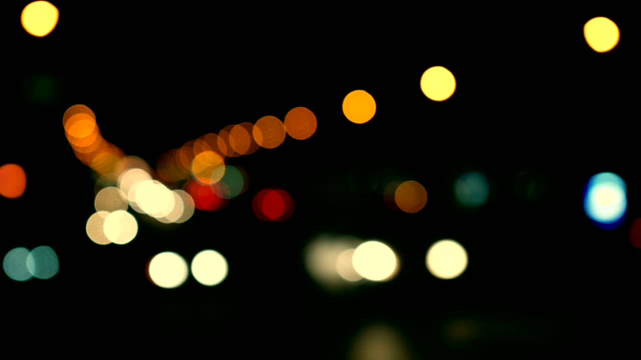 luces desenfocadas calle de los ángeles resumen. fondo borroso de la ciudad. círculos de bokeh en movimiento del tráfico nocturno.
