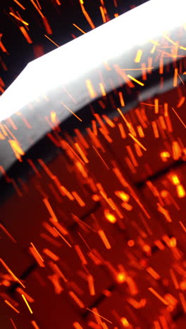 numerous shining particles being emitted from a stove pipe. orange and yellow sparks flying fast at black backdrop. vertical video