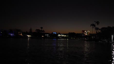 city lights reflecting on river at night