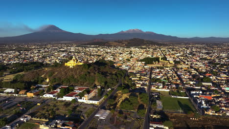 aerial view overlooking the cityscape of cholula, golden hour in puebla, mexico