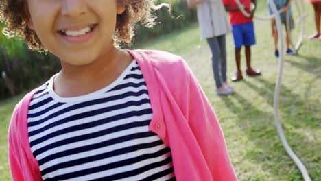 Portrait-of-happy-girl-standing-in-backyard-4k