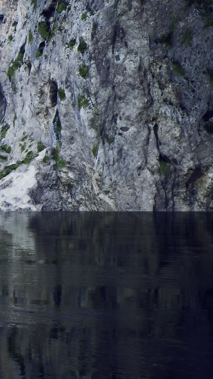 Vast reflections of tranquil waters against majestic rugged cliffs