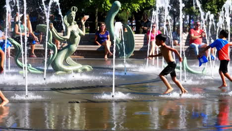 children playing in a fountain