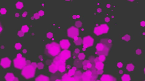 puntos rosados vibrantes esparcidos contra un fondo oscuro