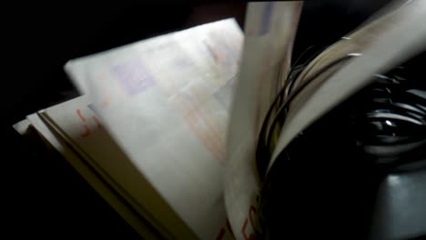 euro banknotes being dispensed or counted