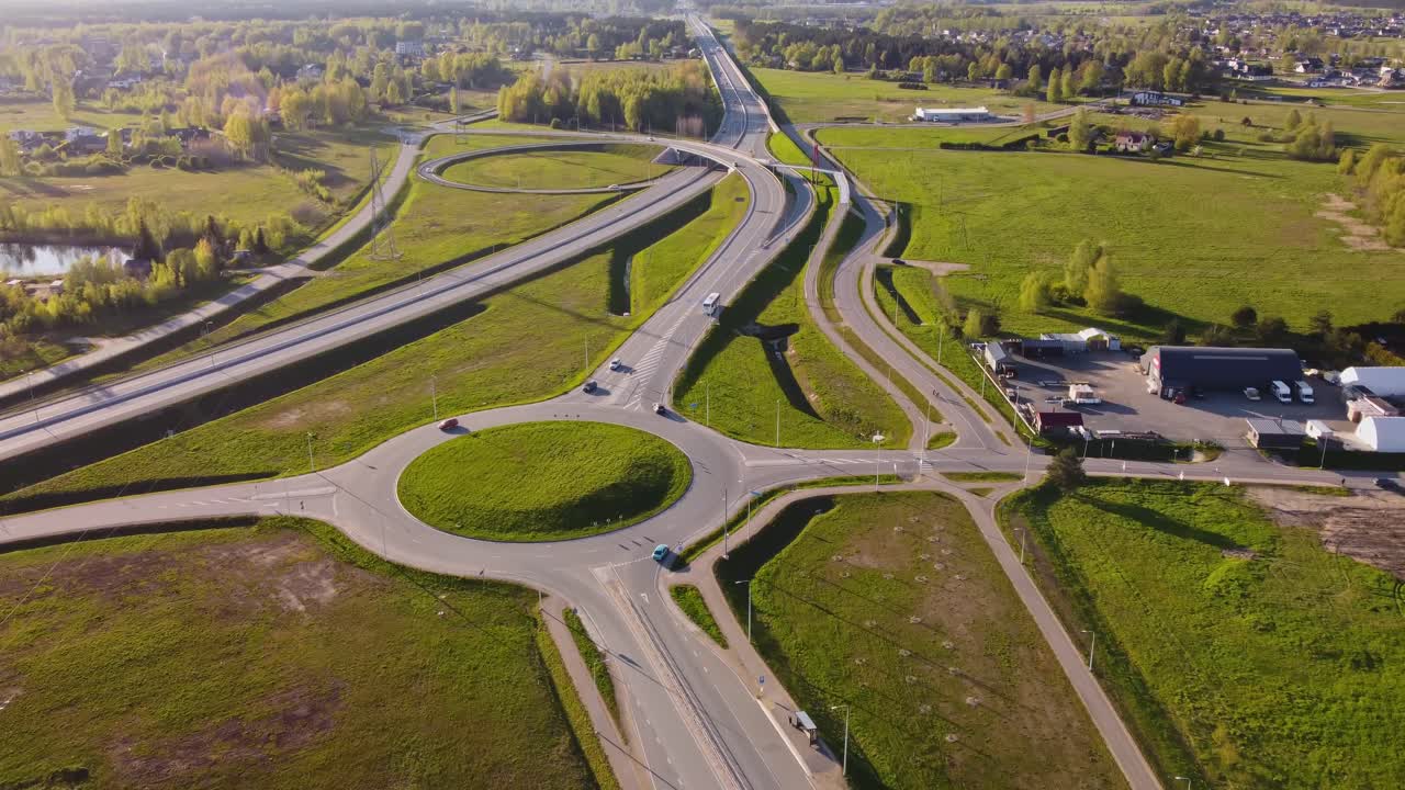 Springtime aerial of Katlakalns with highway traffic and suburban housing area