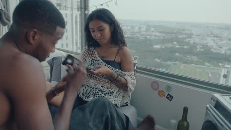 young couple having home party with retro tape cassette player