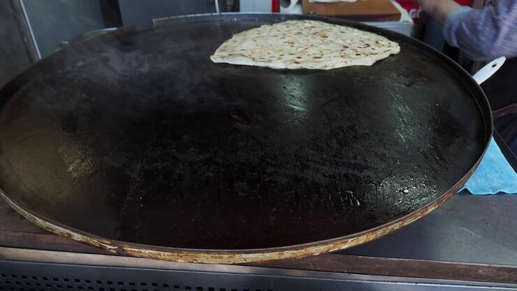 Cooking Turkish Flatbread on a Large Pan