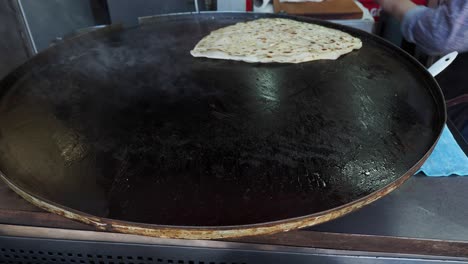 cooking turkish flatbread on a large pan