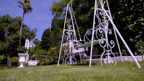 balancing white swing in a park in slow motion